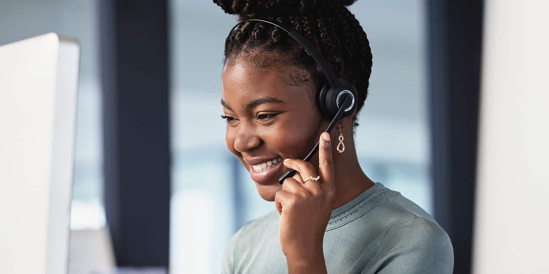 A phone operator answering a call wearing headphones.